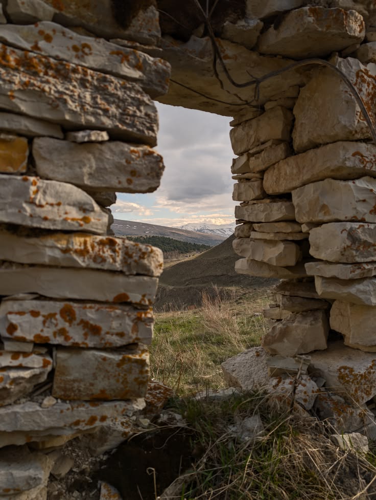View through an old stone opening overlooking the landscape